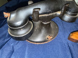 Antique hammered metal pitchers, a vintage black telephone device, and a wooden-stock pistol - thumbnail 3 of 4
