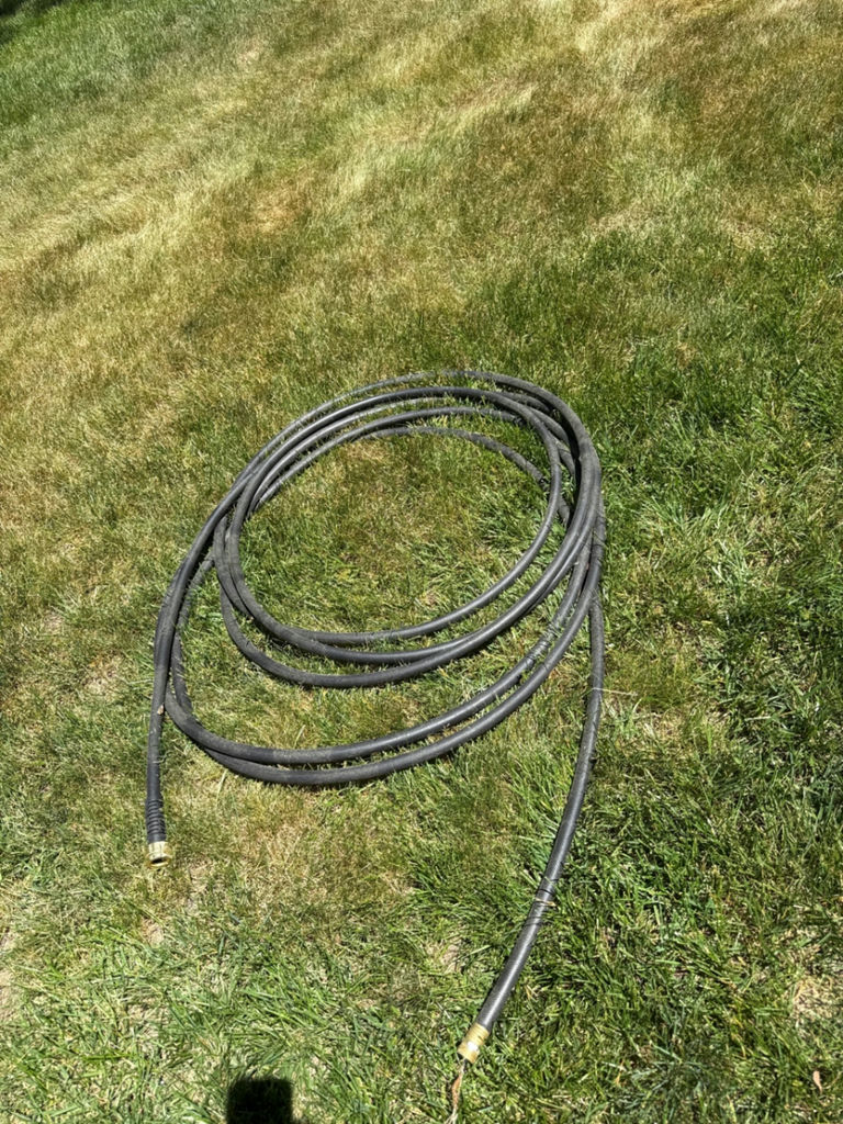 Coiled black hose with brass fittings - image 1 of 2