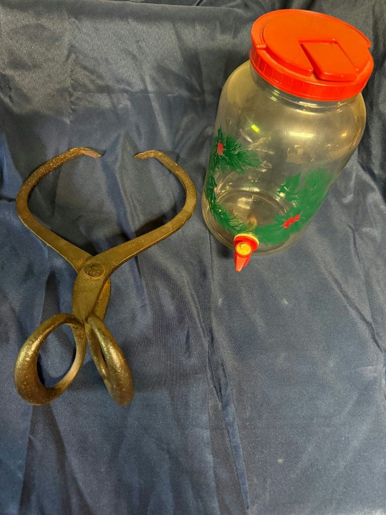 Glass beverage dispenser with red lid and antique iron tongs - image 3 of 3