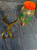 Glass beverage dispenser with red lid and antique iron tongs - thumbnail 3 of 3
