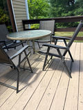 Round glass-top patio table with four metal chairs - thumbnail 2 of 3