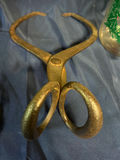 Glass beverage dispenser with red lid and antique iron tongs - thumbnail 2 of 3