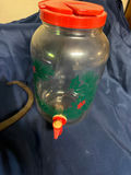 Glass beverage dispenser with red lid and antique iron tongs - thumbnail 1 of 3