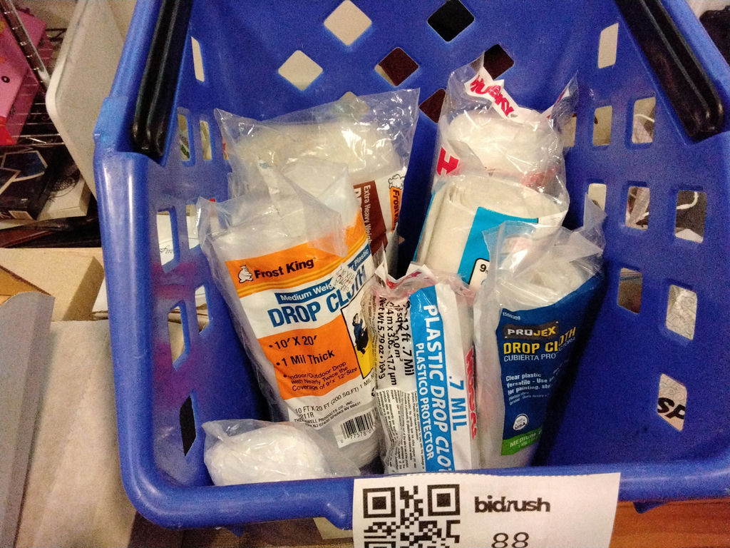 Blue recycling bin filled with cleaning supplies and drop cloths - image 3 of 3