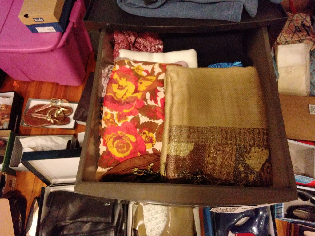 Stacked storage drawers with clothing and fabrics - image 2 of 6