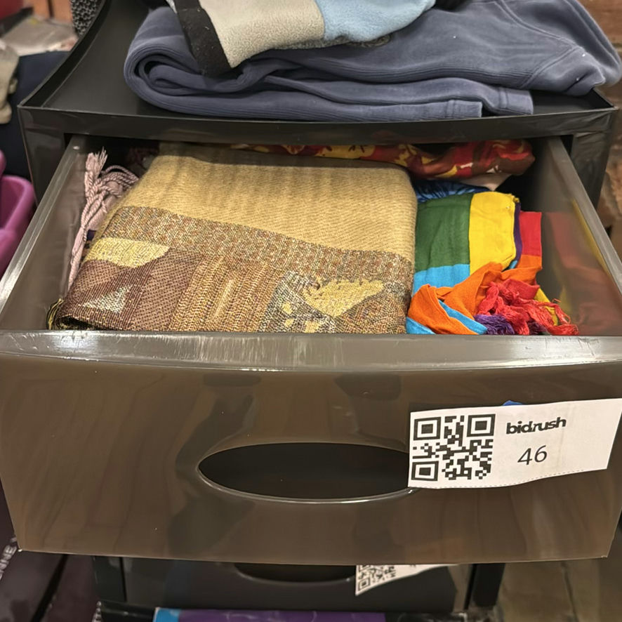 Stacked storage drawers with clothing and fabrics - image 5 of 6