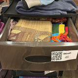 Stacked storage drawers with clothing and fabrics - thumbnail 5 of 6