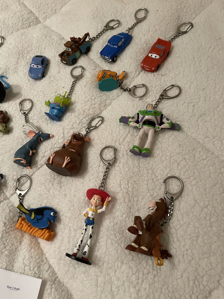 Assorted Disney and Pixar Character Keychains and Figurines With. Spider-Man Popcorn tin - image 3 of 7