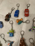 Assorted Disney and Pixar Character Keychains and Figurines With. Spider-Man Popcorn tin - thumbnail 5 of 7