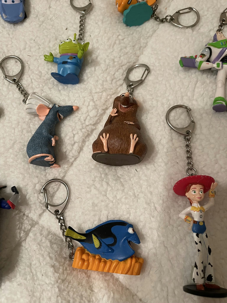 Assorted Disney and Pixar Character Keychains and Figurines With. Spider-Man Popcorn tin - image 2 of 7