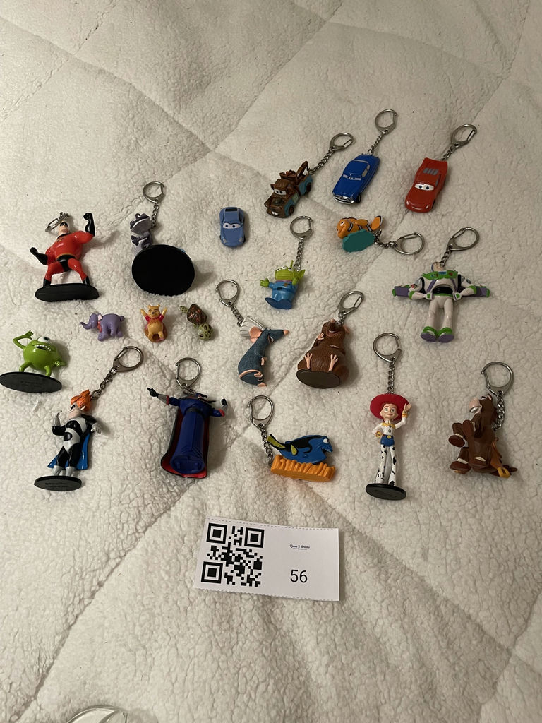 Assorted Disney and Pixar Character Keychains and Figurines With. Spider-Man Popcorn tin - image 1 of 7