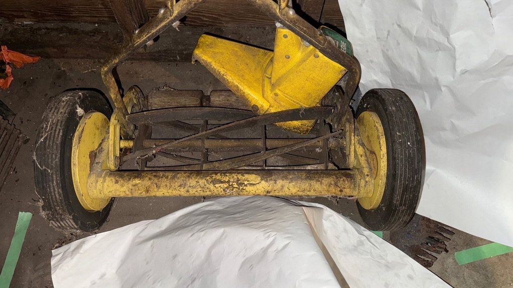 Yellow wheeled lawn dethatcher with garden tools - image 3 of 4