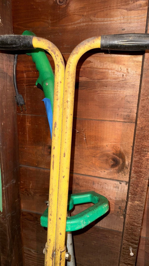 Yellow wheeled lawn dethatcher with garden tools - image 1 of 4