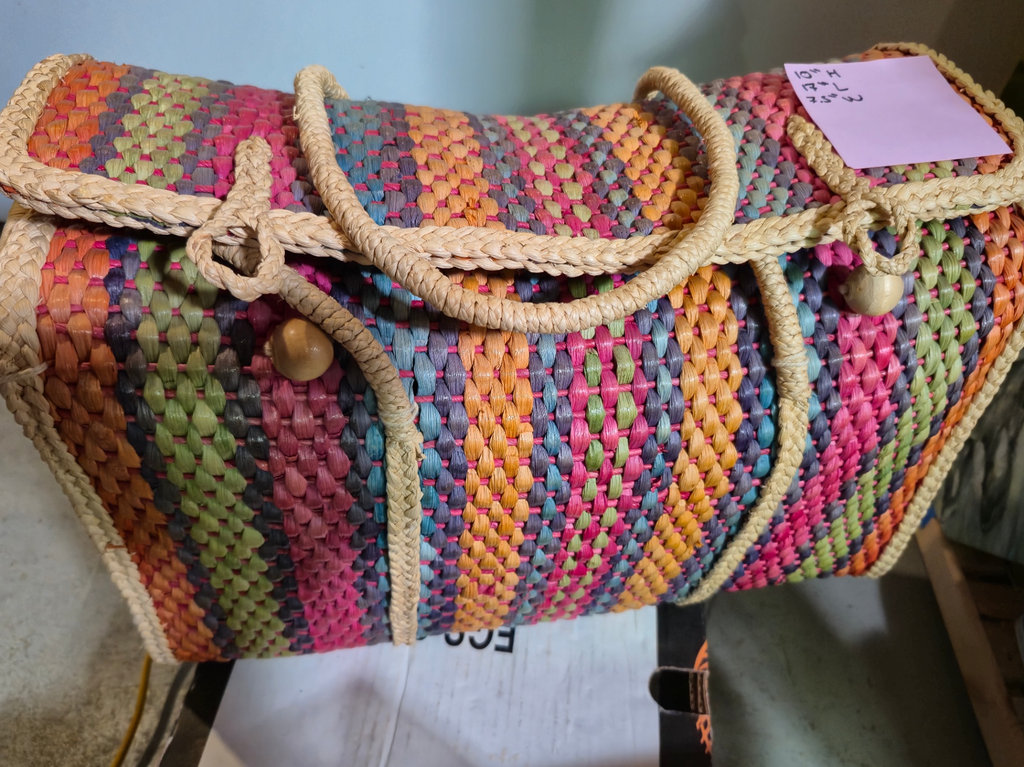 Multicolored woven handbag with assorted kitchenware and packaging items - image 1 of 3