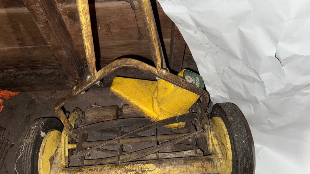 Yellow wheeled lawn dethatcher with garden tools - image 4 of 4