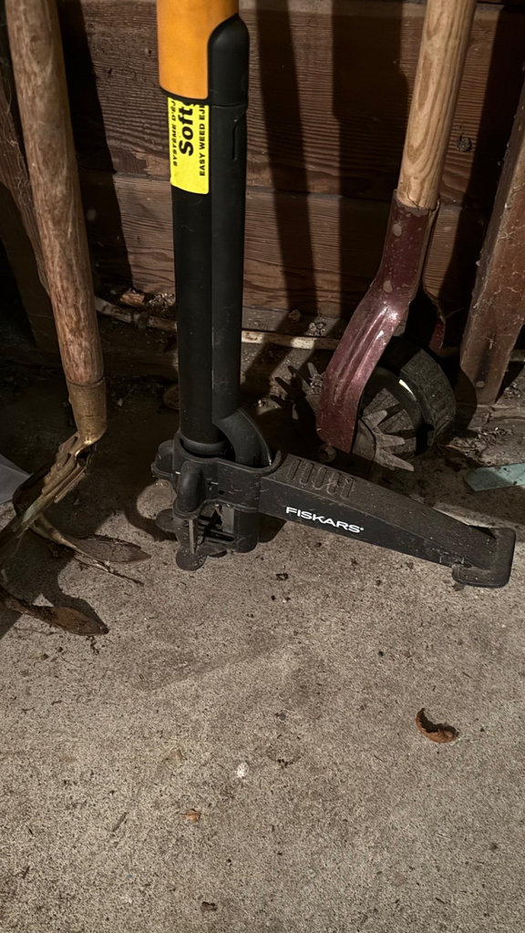 Garage tool collection with shovels, cords, and tarps - image 4 of 6
