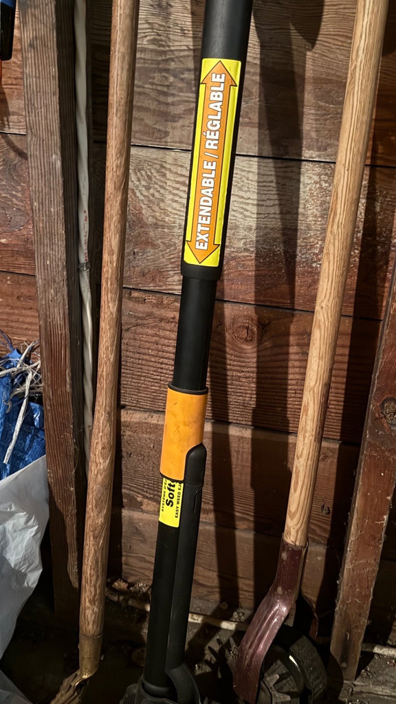 Garage tool collection with shovels, cords, and tarps - image 3 of 6