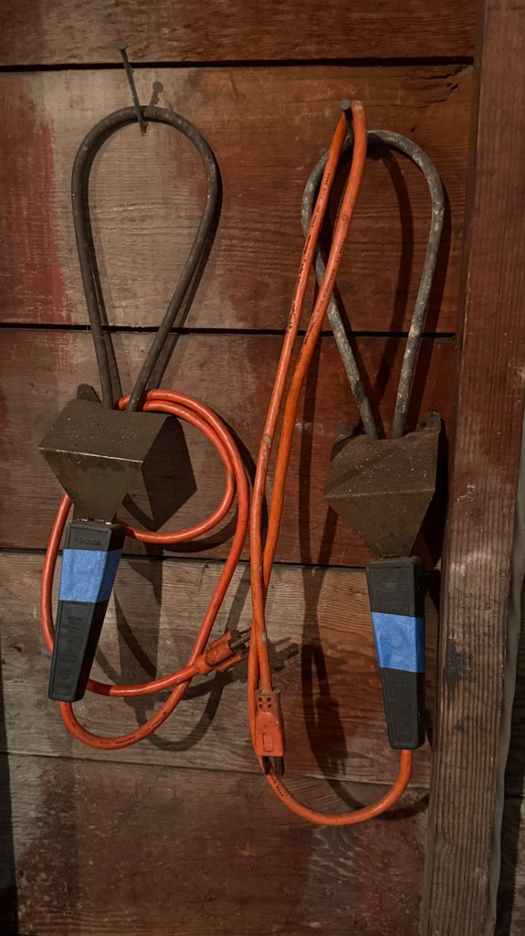 Garage tool collection with shovels, cords, and tarps - image 2 of 6