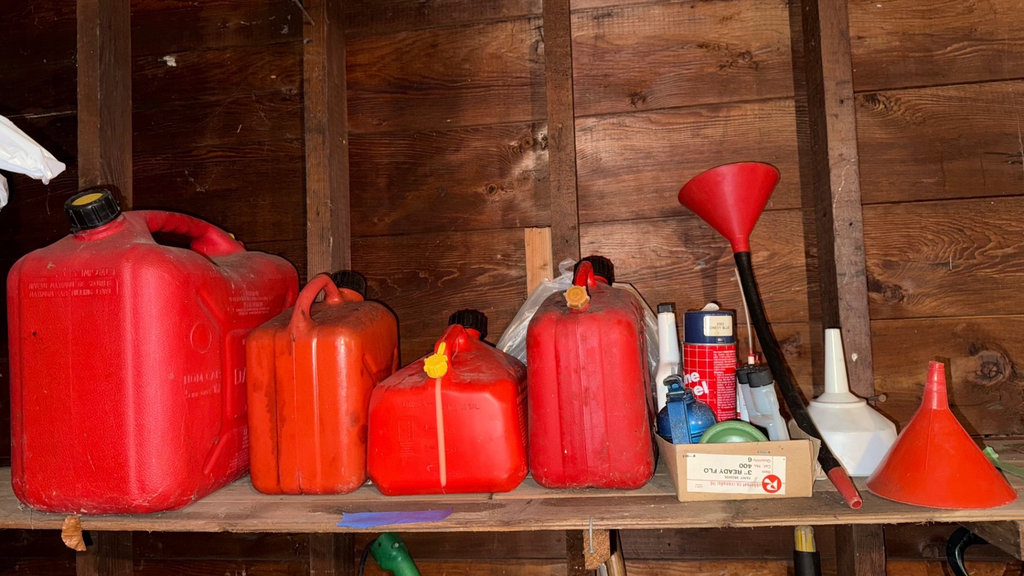 Assorted red gas cans and automotive supplies - image 1 of 3