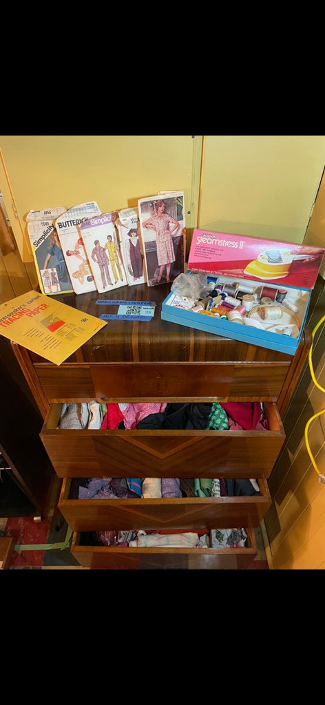Vintage sewing patterns with fabric scraps and sewing tools - image 1 of 7