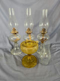 Lot of (4) Vintage Glass Kerosene & Oil Lamps - Clear Pedestal & Amber Pressed Glass Fonts with Extra Chimney - thumbnail 1 of 4