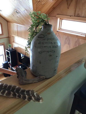 Antique embossed stoneware jug with plant and driftwood - Image 1 of 3