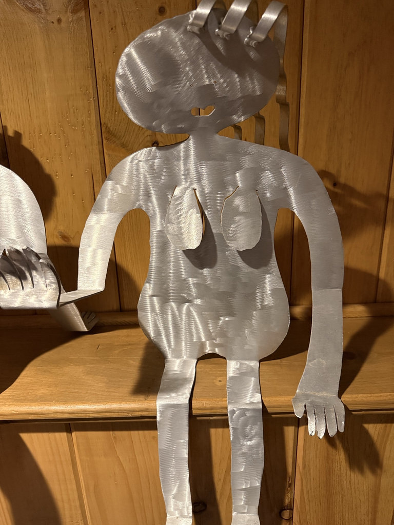 Two metal silhouette sculptures of seated humanoid figures - image 2 of 5