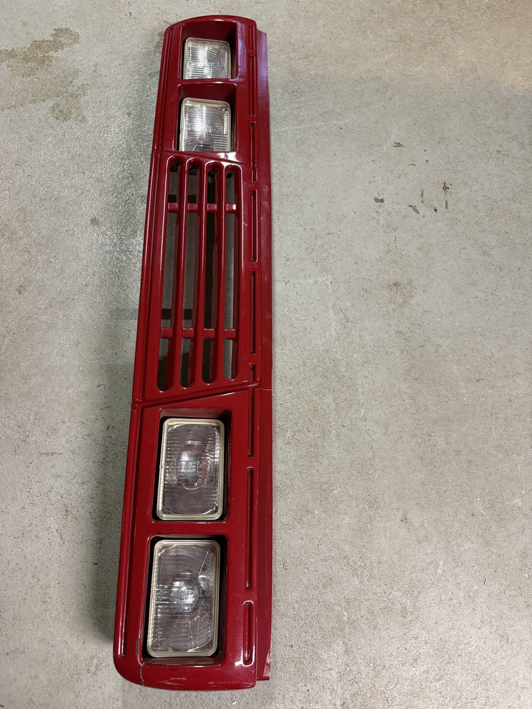 Red front grille with integrated rectangular headlights and related automotive parts - image 1 of 7