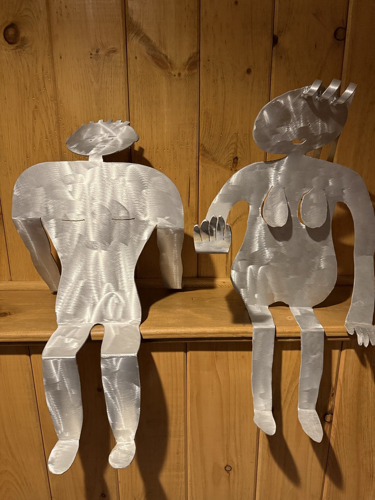 Two metal silhouette sculptures of seated humanoid figures - image 1 of 5