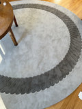 Round taupe rug with decorative border - thumbnail 3 of 4