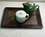Green teapot with infuser, lavender-patterned cup and lid, on ornate decorative tray - thumbnail 1 of 5