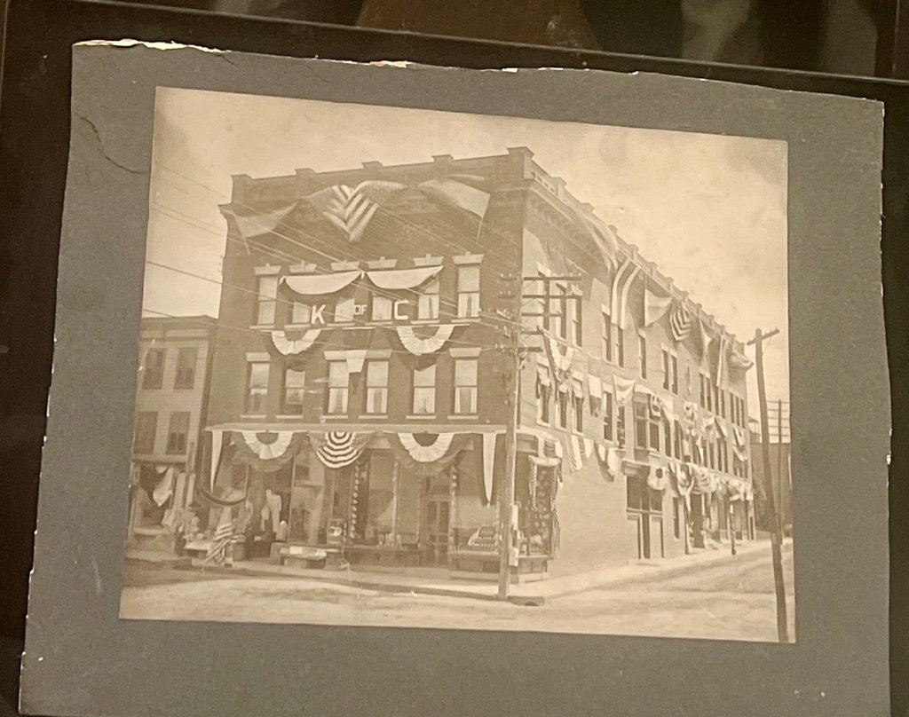 Cabinet Photo Holiday decorated small city building and general store about 1900 American flags - image 1 of 5