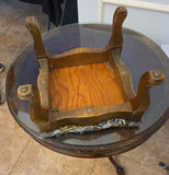 Round glass-top pedestal table with carved wooden base and floral upholstered ottoman - thumbnail 6 of 6