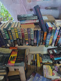 Assorted fiction books in stacks and boxes - thumbnail 7 of 10