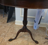 Round glass-top pedestal table with carved wooden base and floral upholstered ottoman - thumbnail 2 of 6