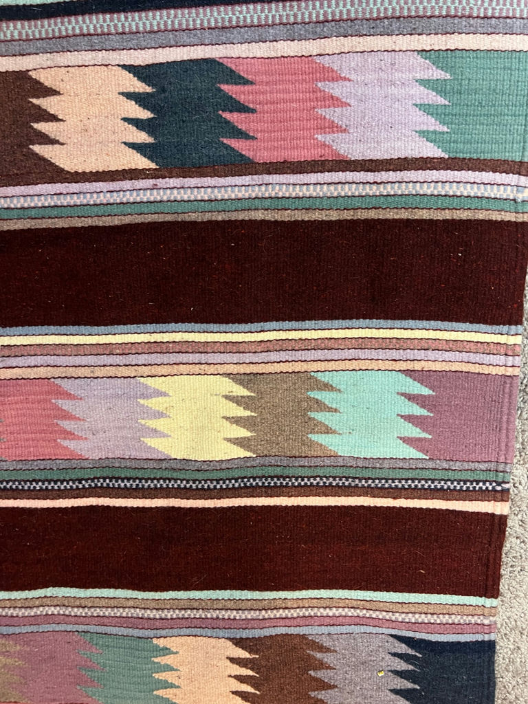 Geometric patterned woven rug with fringe and a white card with a square code - 50" x 29" - image 3 of 4