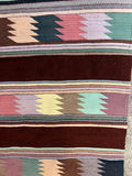 Geometric patterned woven rug with fringe and a white card with a square code - 50" x 29" - thumbnail 3 of 4