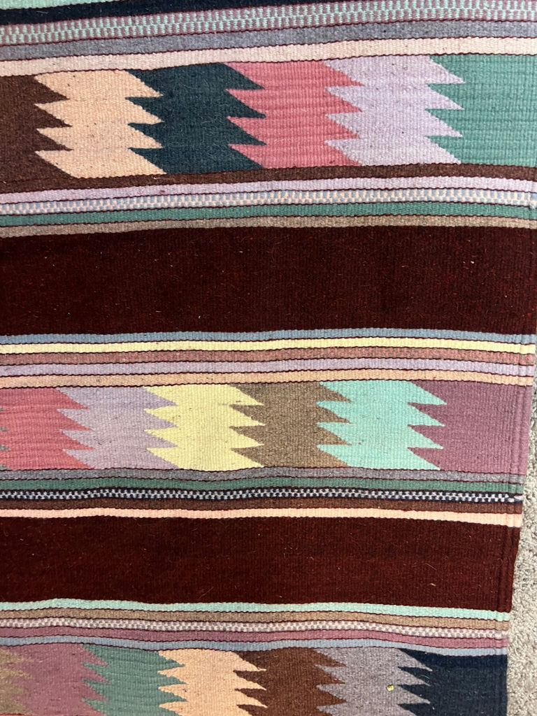 Geometric patterned woven rug with fringe and a white card with a square code - 50" x 29" - image 2 of 4