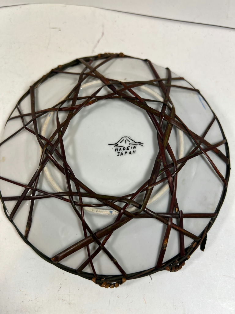 Pair of hand-painted porcelain plates with floral and bird designs in wicker frames - image 5 of 5
