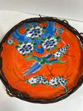 Pair of hand-painted porcelain plates with floral and bird designs in wicker frames - thumbnail 3 of 5
