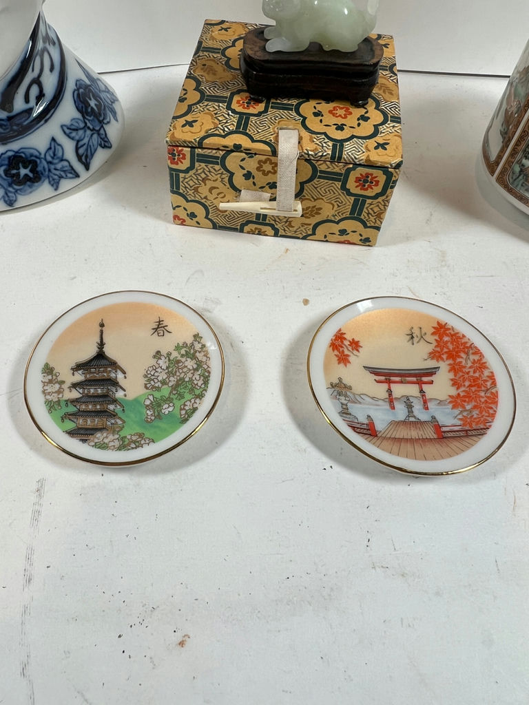 Blue-and-white porcelain head vase, decorative patterned box with jade figurine, cylindrical landscape ceramic vessel, and two seasonal plates - image 5 of 5