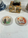 Blue-and-white porcelain head vase, decorative patterned box with jade figurine, cylindrical landscape ceramic vessel, and two seasonal plates - thumbnail 5 of 5