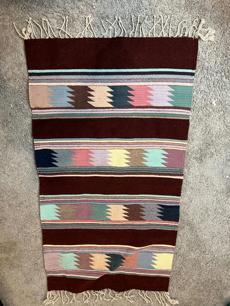 Geometric patterned woven rug with fringe and a white card with a square code - 50" x 29" - image 1 of 4
