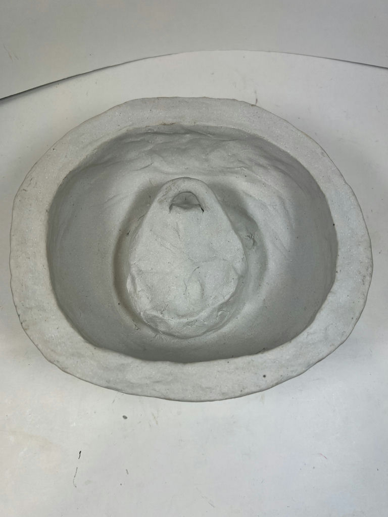 Circular ceramic bowl with carved interior face relief - image 2 of 3