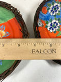 Pair of hand-painted porcelain plates with floral and bird designs in wicker frames - thumbnail 4 of 5