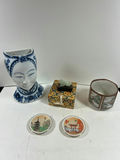 Blue-and-white porcelain head vase, decorative patterned box with jade figurine, cylindrical landscape ceramic vessel, and two seasonal plates - thumbnail 1 of 5