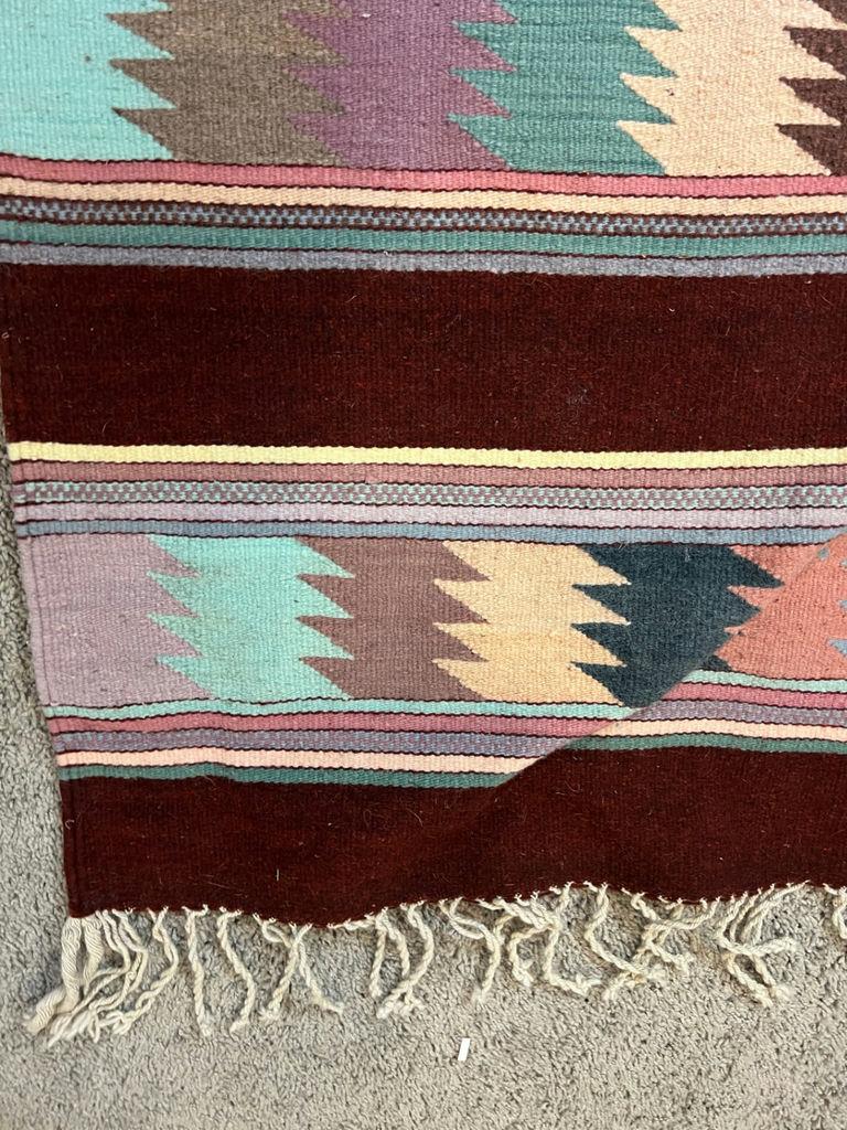 Geometric patterned woven rug with fringe and a white card with a square code - 50" x 29" - image 4 of 4