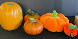Assorted Halloween decor: plush pumpkins, cow-patterned cushion, and vintage candle box - thumbnail 1 of 6