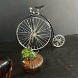 Mint-green clock, teal ruffled vase, brass-lidded container, penny-farthing bicycle sculpture, amber decanter, and glass pumpkin - thumbnail 6 of 6