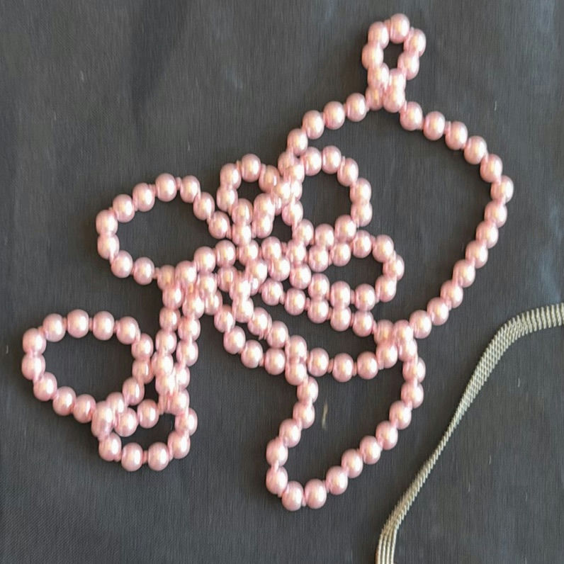 Assorted necklaces: pink pearl strand, colorful beaded necklace, and wood pendant necklace - image 4 of 5